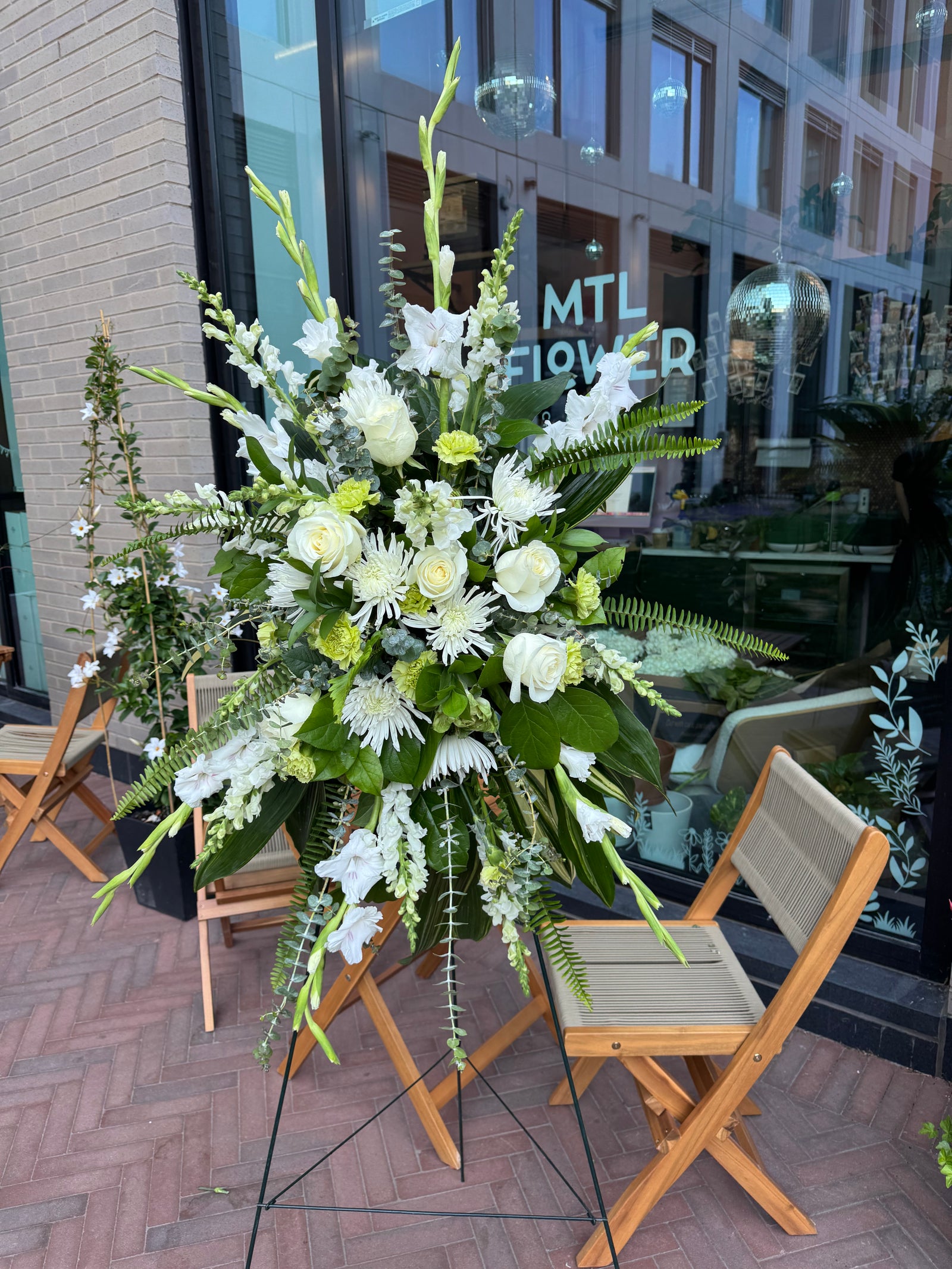 Floral arrangement on a table with a building in the background