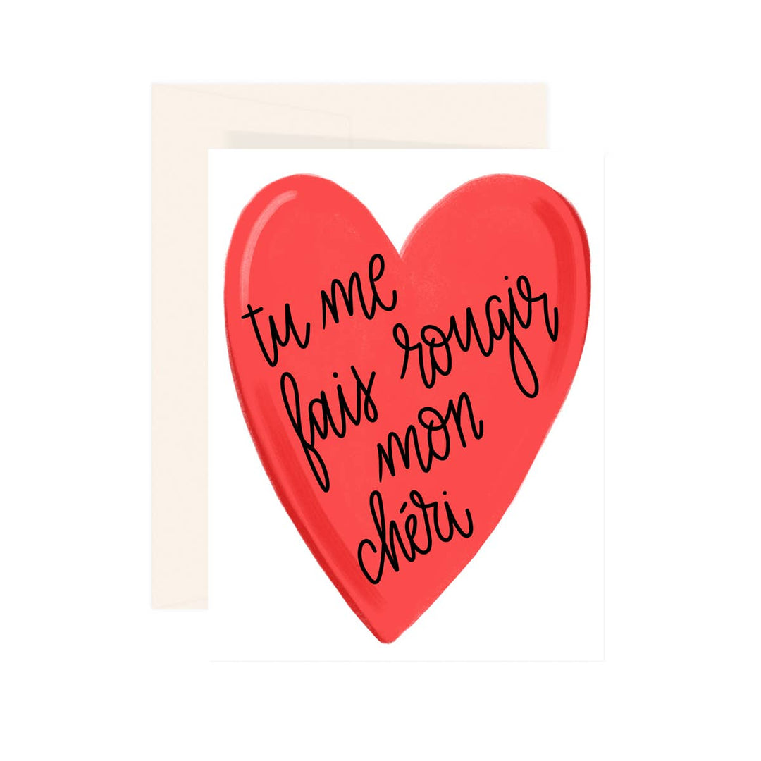 Red heart-shaped sign with French text on a white background