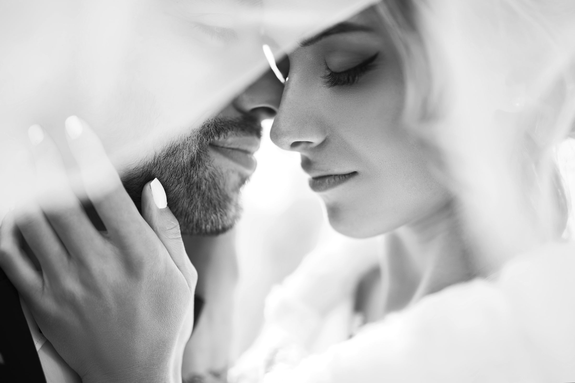 Black and white close-up of a couple embracing