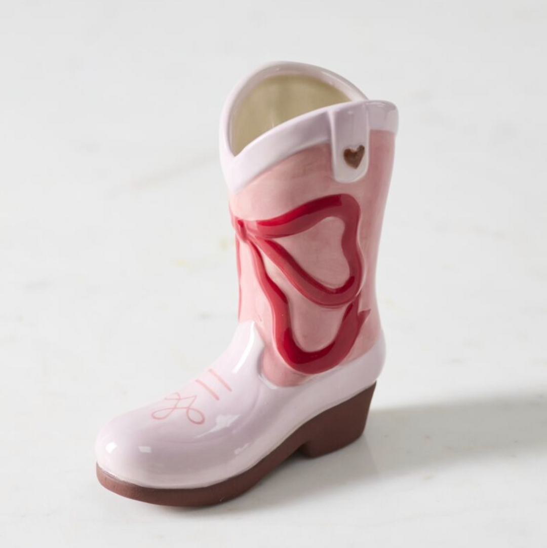 Pink rain boot with a heart design on a white background
