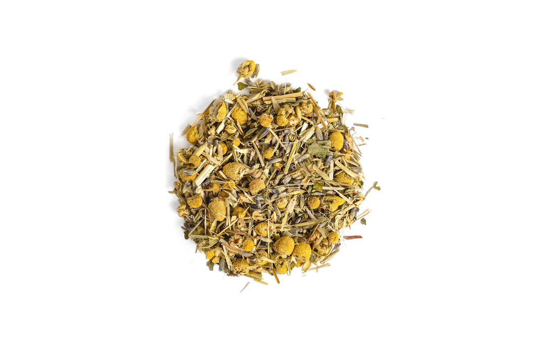 Heap of dried chamomile flowers on a white background