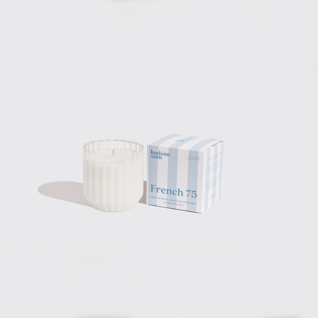 Candle and packaging labeled 'French 75' on a white background